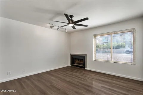 a living room with furniture a flat screen tv and a large window