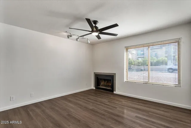a living room with furniture a flat screen tv and a large window
