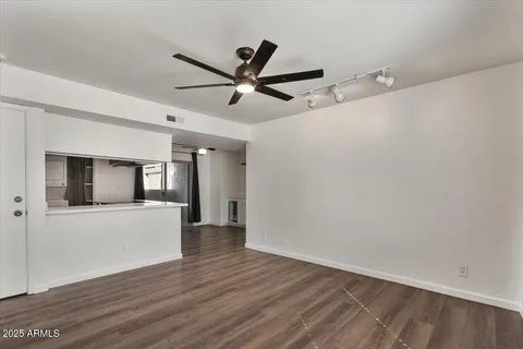 a living room with furniture a flat screen tv and a potted plant