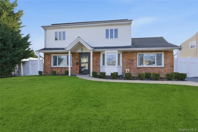 a front view of a house with a garden and porch