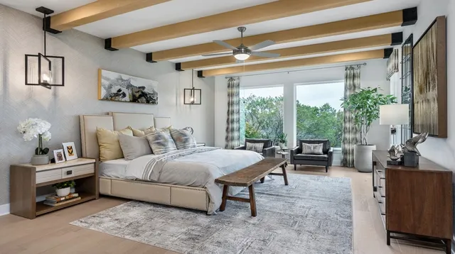 a bedroom with a bed a table and chair