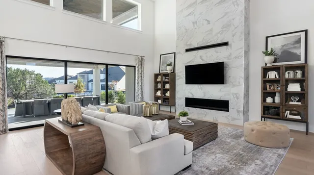 a living room with furniture a flat screen tv and a fireplace