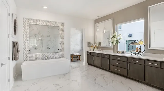 a bathroom with a tub a sink shower double vanity