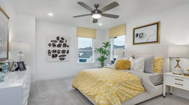 a bedroom with a bed and painting on the wall