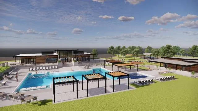 a view of a tennis ground with large trees