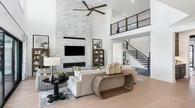 a living room with furniture a flat screen tv and a fireplace