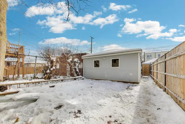 a view of a house with a snow in the yard