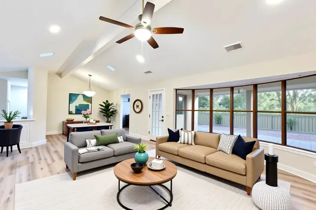 a living room with furniture and a large window