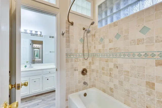 a bathroom with a shower a sink and a mirror