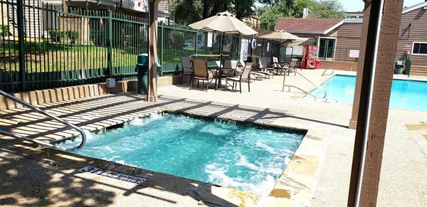 a view of a patio with a dining table and chairs with wooden floor