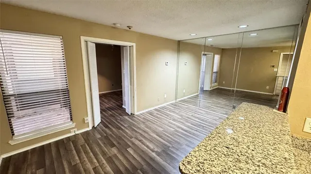 a view of room with wooden floor