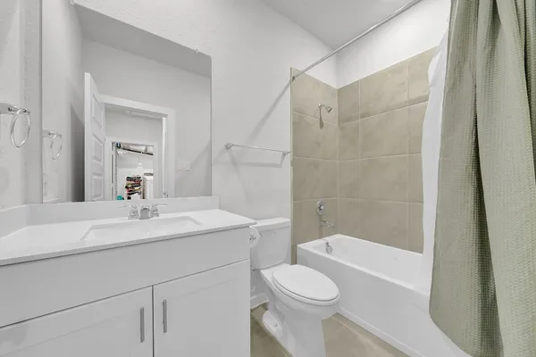 a spacious bedroom with a bed and a window