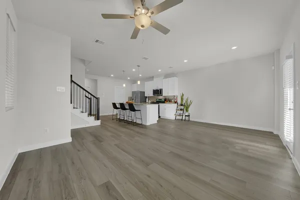 a kitchen with stainless steel appliances granite countertop a sink stove and cabinets
