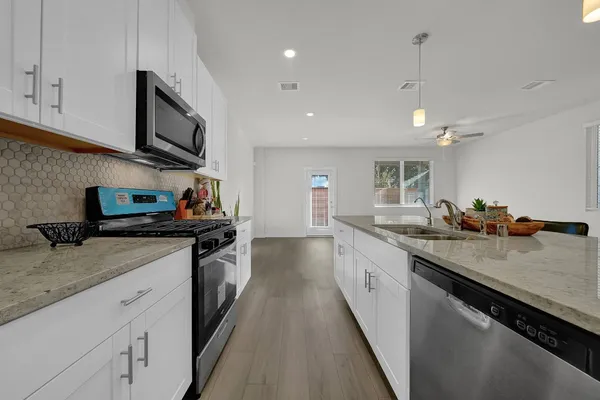 a view of kitchen with furniture and wooden floor
