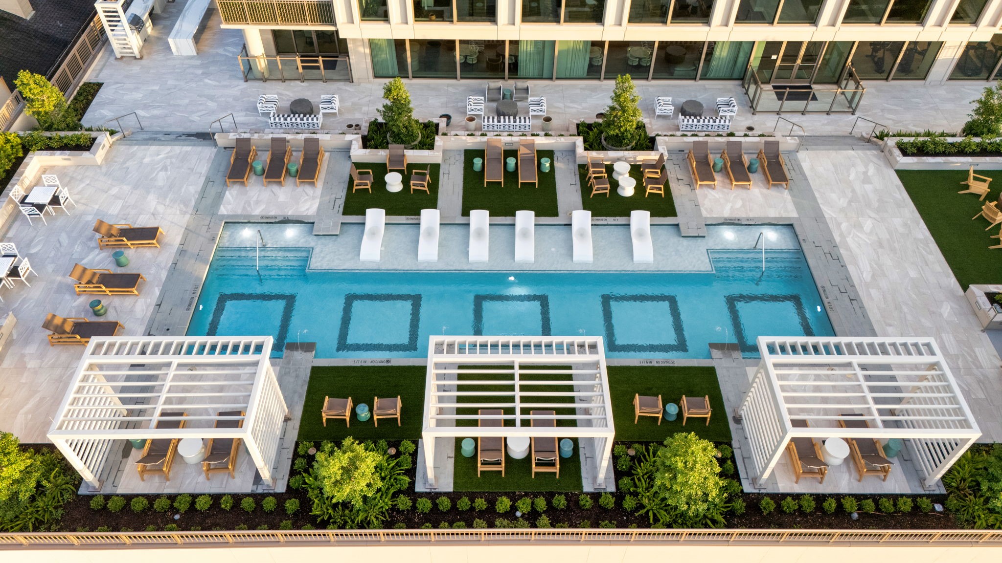 5656 San Felipe Street, Unit 701 Houston, TX 77056 - Photo 33 of 44 An aerial capturing a stunning bird's-eye view of the pool area, showcasing the symmetry of custom decking and the flawless of the geometric design.