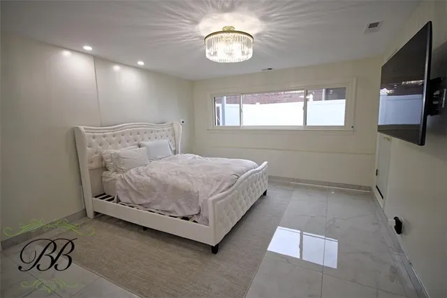 a bedroom with a bed and a television