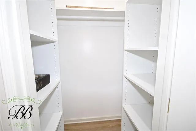 a view of walk in closet with clothes
