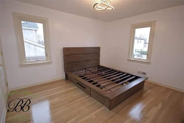 a view of a room with wooden floor and window