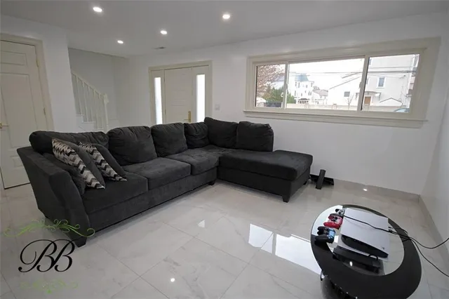 a living room with furniture a couch and a window