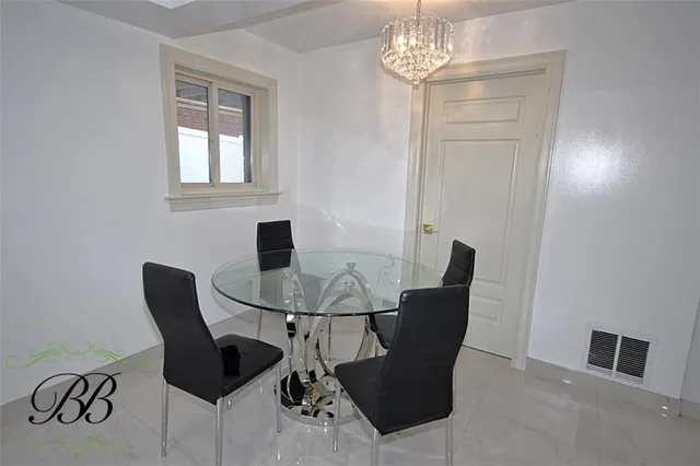 a view of a dining room with furniture and chandelier