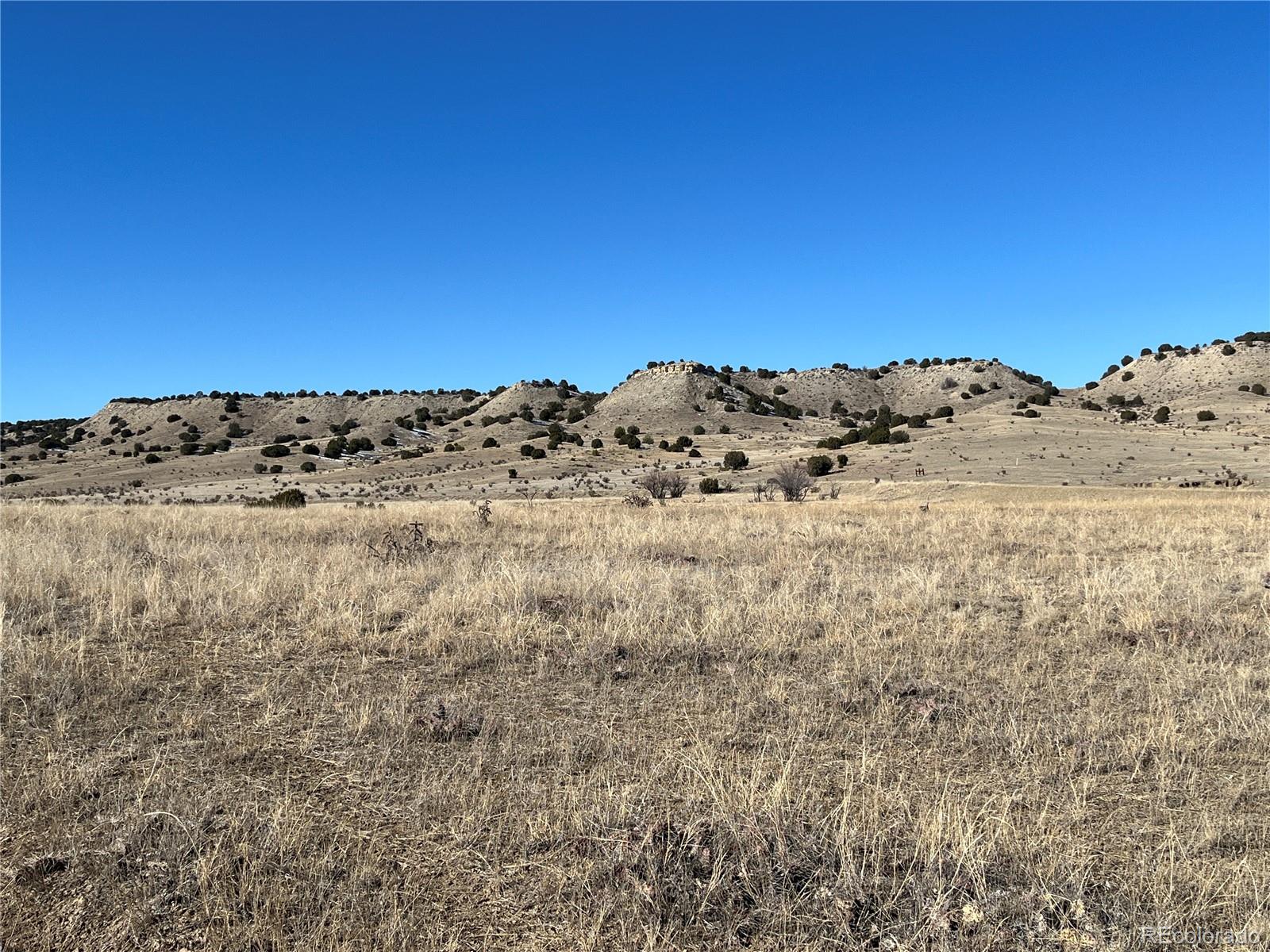 53 Horse Creek Road Pueblo, CO 81004 - Photo 2 of 34 a view of a large building with a mountain in the background