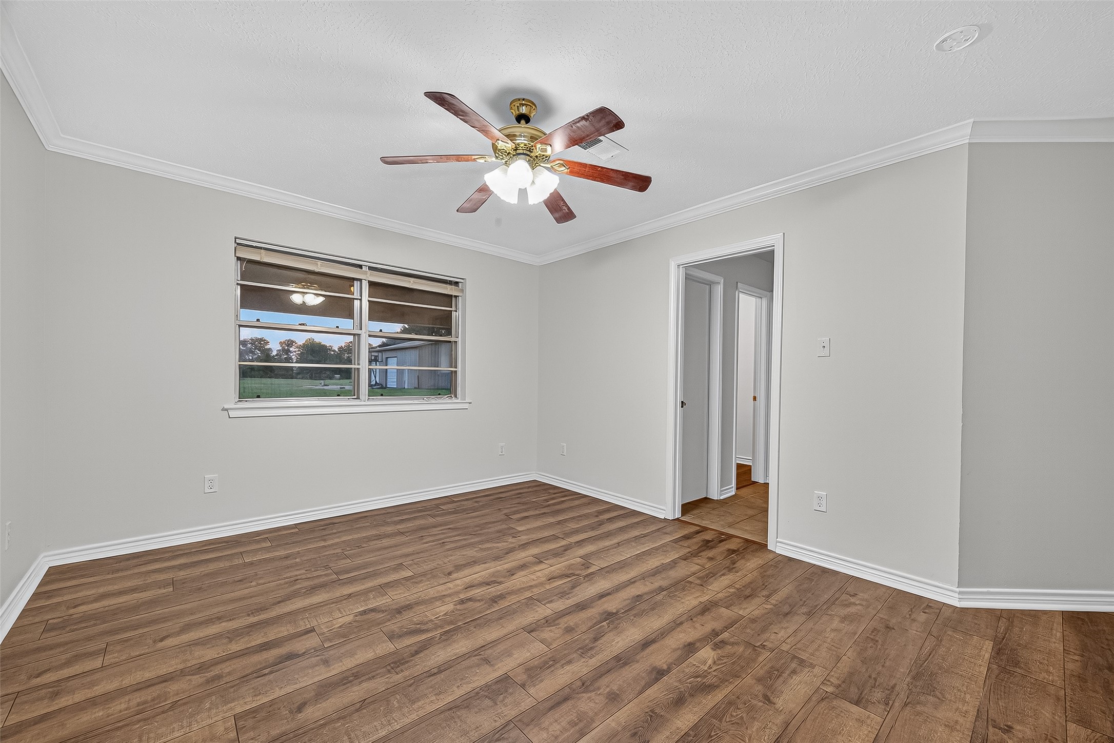 3122 Kueck Road Rosenberg, TX 77471 - Photo 14 of 25 a view of an empty room with window and wooden floor