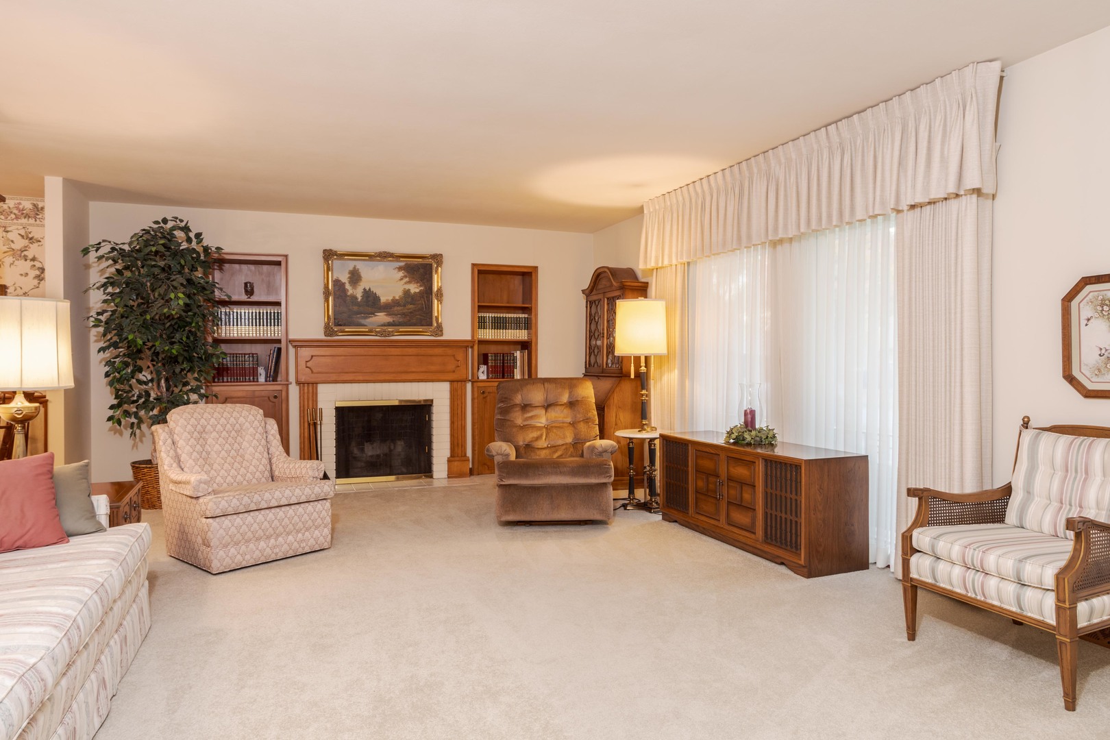 11 Manor Drive Pontiac, IL 61764 - Photo 8 of 45 a living room with furniture a fireplace and a large window