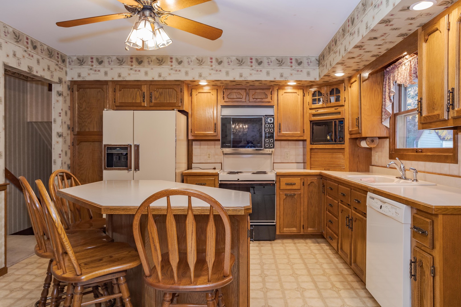 11 Manor Drive Pontiac, IL 61764 - Photo 10 of 45 a kitchen with stainless steel appliances a dining table and chairs