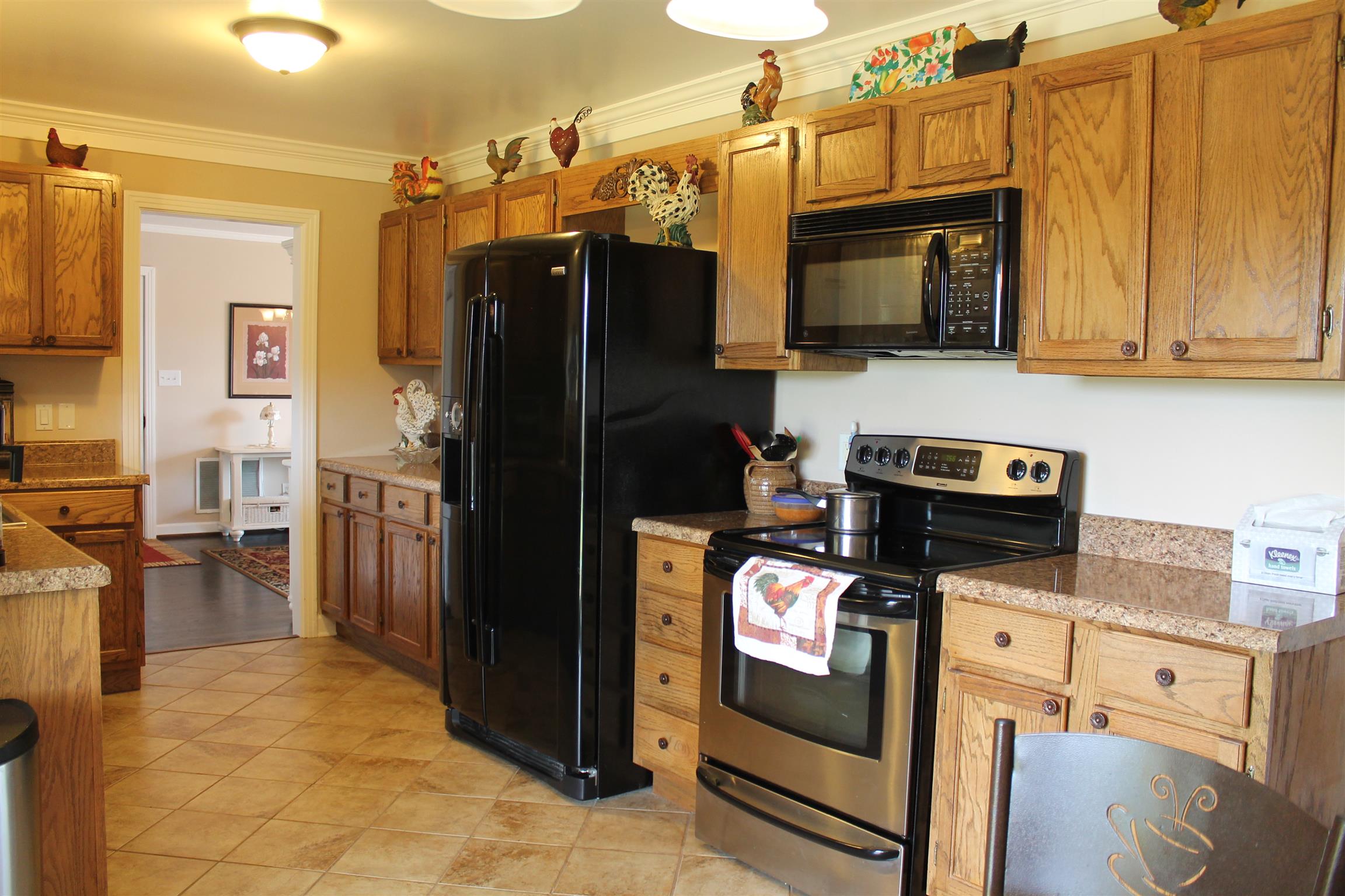 107 Lakeview Drive Dickson, TN 37055 - Photo 18 of 30 a kitchen with stainless steel appliances granite countertop a refrigerator stove and microwave