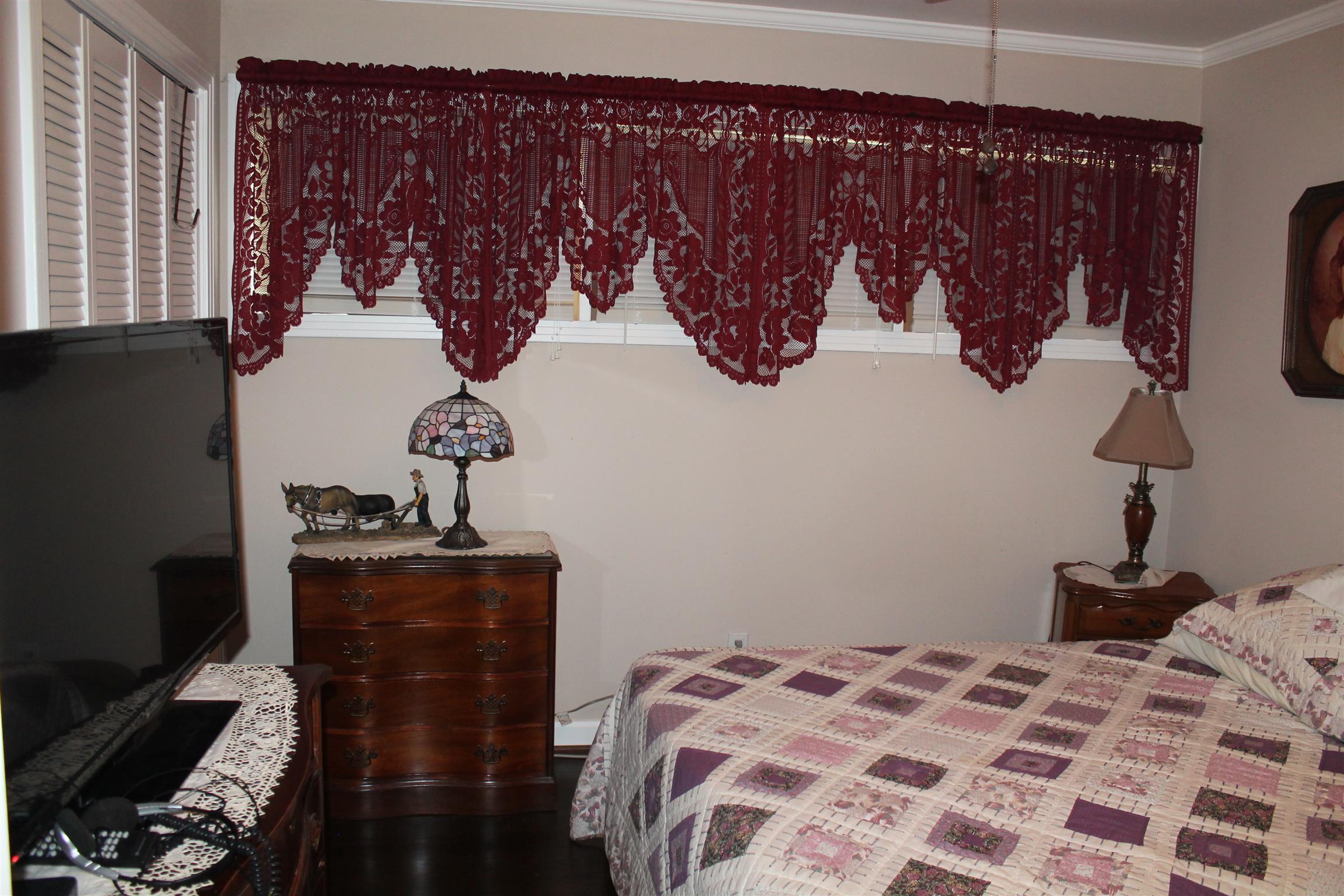 107 Lakeview Drive Dickson, TN 37055 - Photo 25 of 30 a bedroom with a bed and wooden floor