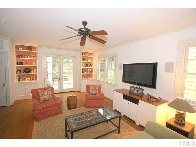3938 Dover Road Durham, NC 27707 - Photo 6 of 11 Built in bookcases and cabinets are functional and attractive. Glass doors lead to stone patio