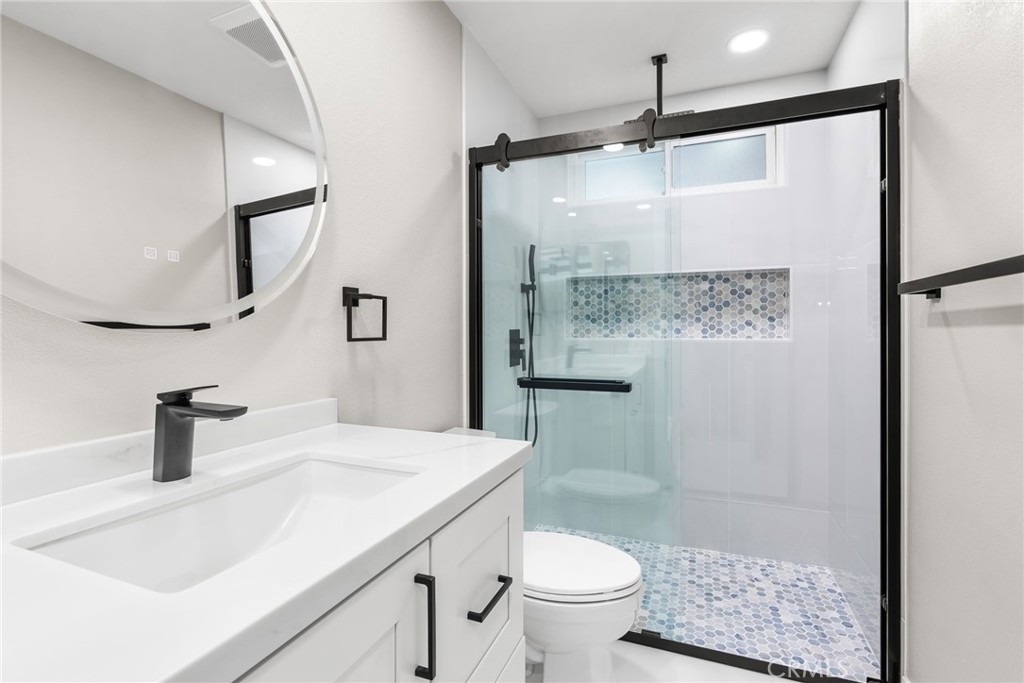 24746 Scott Lane Lake Forest, CA 92630 - Photo 18 of 31 a bathroom with a sink a toilet and shower