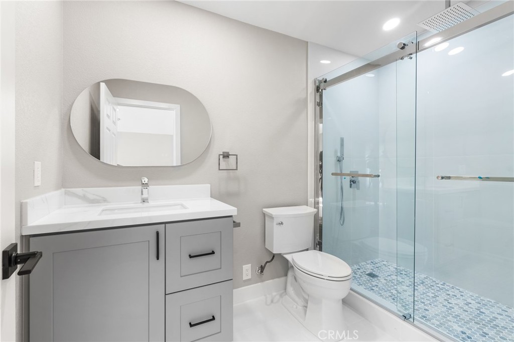 24746 Scott Lane Lake Forest, CA 92630 - Photo 21 of 31 a bathroom with a toilet sink vanity granite and shower