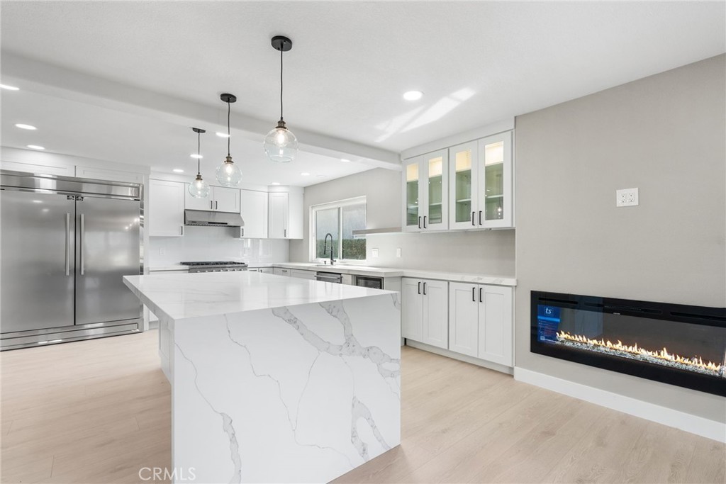 24746 Scott Lane Lake Forest, CA 92630 - Photo 10 of 31 a large kitchen with kitchen island a large counter top a sink stainless steel appliances and cabinets