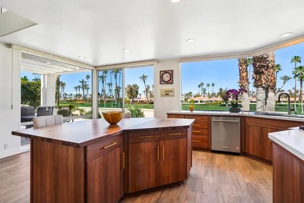 a kitchen with stainless steel appliances granite countertop a sink and wooden cabinets