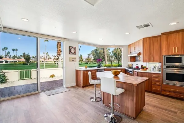 a kitchen with a table chairs and wooden floor