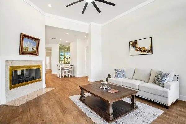 a living room with furniture a fireplace and a table