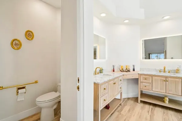 a view of bathroom with a toilet sink and mirror