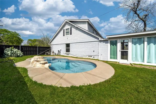 a view of a house with swimming pool and porch