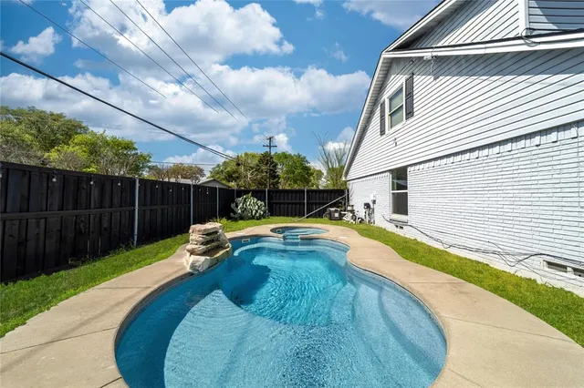 a view of a swimming pool with a backyard