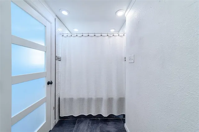 a bathroom with a mirror and a shower
