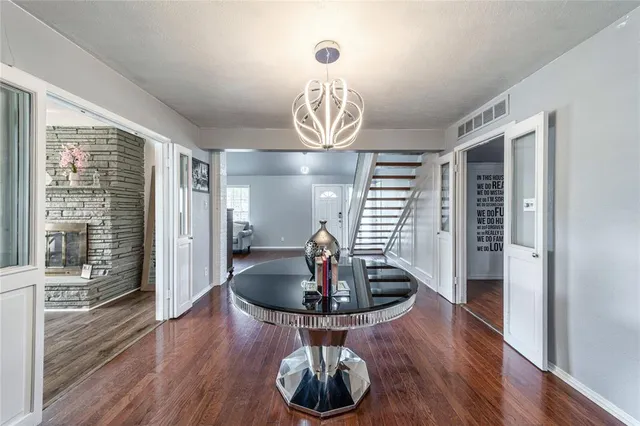 a view of dining room with wooden floor and large windows