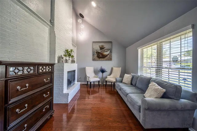 a living room with furniture a rug and a window
