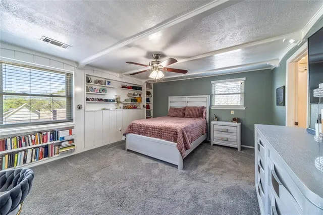 a bedroom with a bed furniture and a book shelf