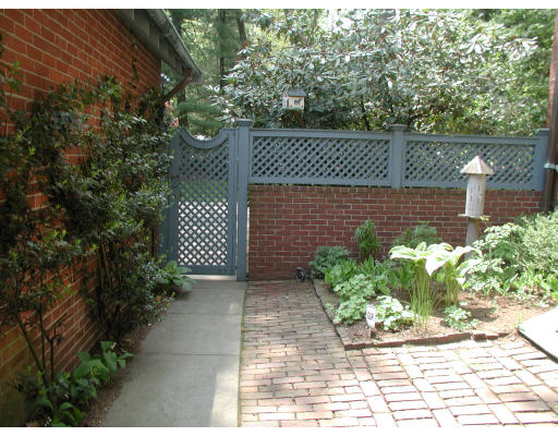 12 Whiting Road Wellesley, MA 02481 - Photo 9 of 9 a view of a brick wall with plants and large trees