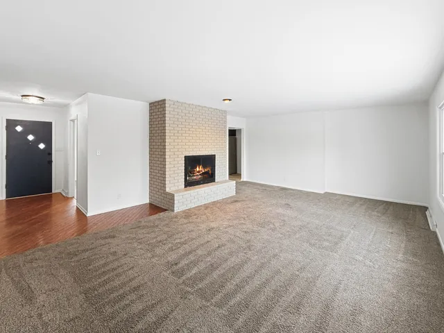 a view of empty room with a fireplace