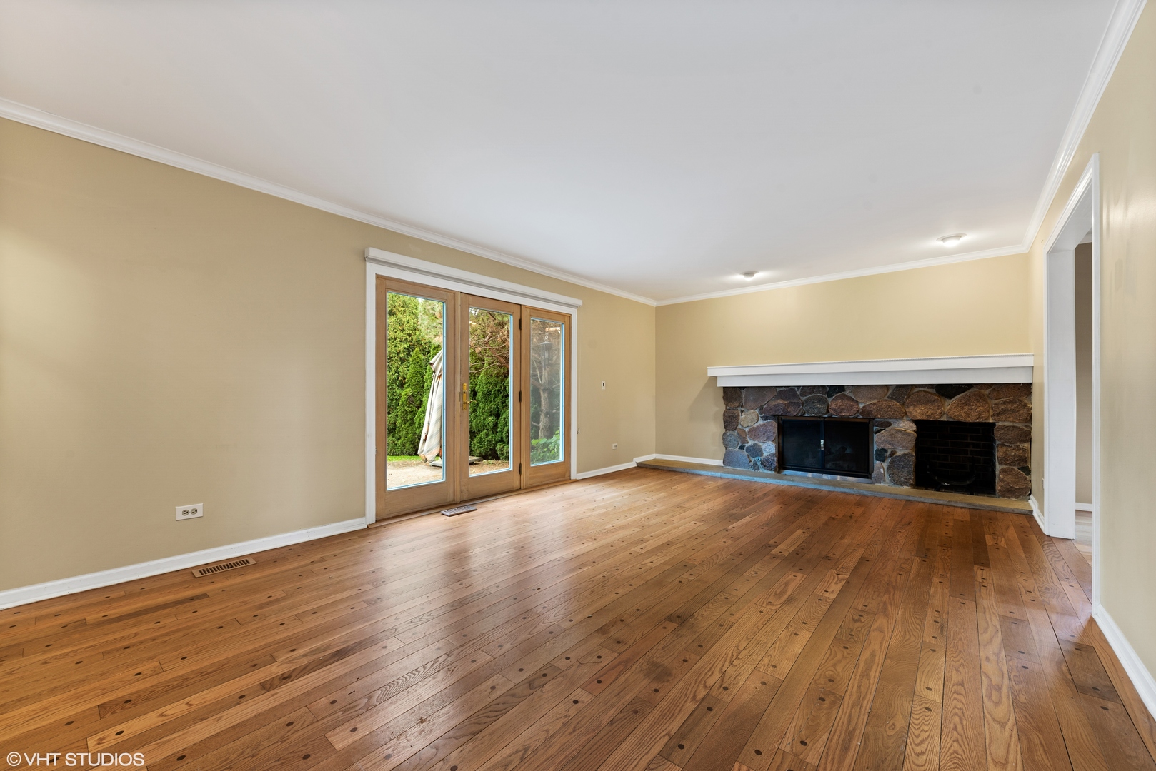 3100 Techny Road Northbrook, IL 60062 - Photo 11 of 28 an empty room with wooden floor fireplace and windows