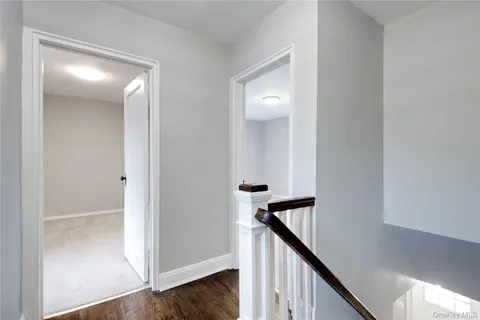 a view of a hallway with wooden floor and entryway