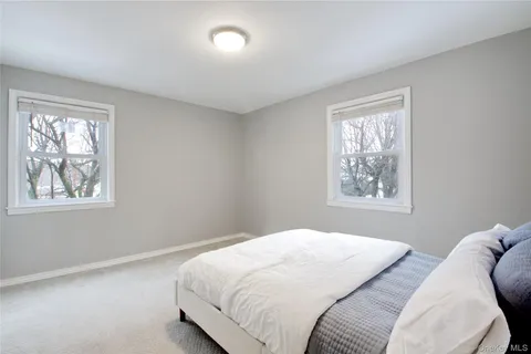 a bedroom with bed and window