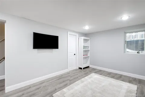 a view of a livingroom with wooden floor and flat screen tv